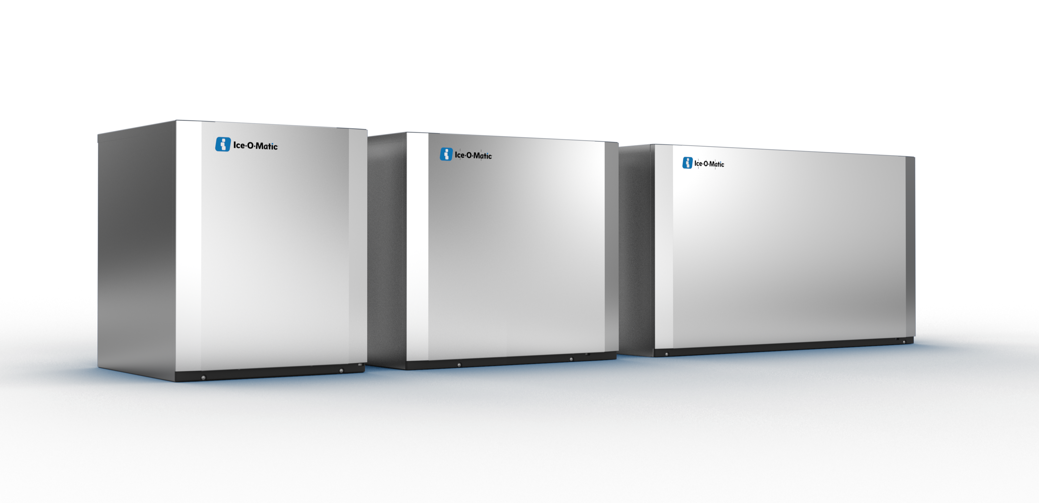 Three Ice-O-Matic cube ice makers lined up against a dark backdrop